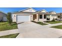 One-story home with light beige siding, white garage door, and covered front porch at 6200 Sw 72Nd Ter, Ocala, FL 34474