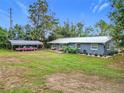 Cute blue house on a large lot with a carport and spacious backyard at 21500 Sw 33Rd St, Dunnellon, FL 34431