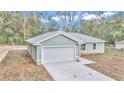 New construction home, gray exterior, attached garage, and large backyard at 2355 Nw 57Th Pl, Ocala, FL 34475