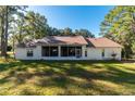 Home exterior showcasing a screened patio and spacious backyard at 4939 Nw 82Nd Ct, Ocala, FL 34482