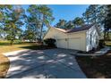 Two-car garage with a large concrete driveway at 4939 Nw 82Nd Ct, Ocala, FL 34482