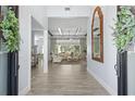 Bright and spacious entryway with hardwood floors and a view into the living room at 8725 Nw 31St Lane Rd, Ocala, FL 34482