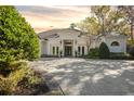 Beautiful home exterior showcasing a white facade and a spacious driveway at 8725 Nw 31St Lane Rd, Ocala, FL 34482