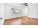 Bright bedroom with wood floors, ceiling fan, and spacious closet at 10962 Sw 81St Ave, Ocala, FL 34481