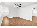 Spacious bedroom with wood floors, ceiling fan, and adjacent bathroom at 10962 Sw 81St Ave, Ocala, FL 34481