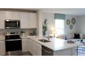 Modern kitchen with island and view into living room at 6612 Sw 81St Loop, Ocala, FL 34476
