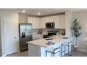 Modern kitchen featuring stainless steel appliances and a breakfast bar at 6620 Sw 81St Loop, Ocala, FL 34476
