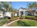 Single-story house with a two-car garage, well-manicured lawn, and a nicely landscaped front yard at 6671 Sw 97Th Terrace Rd, Ocala, FL 34481