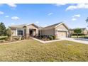 Single story house with a two-car garage and manicured lawn at 9826 Sw 63Rd Loop, Ocala, FL 34481