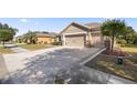 Front view of a single story house with a two-car garage and circular driveway at 9826 Sw 63Rd Loop, Ocala, FL 34481