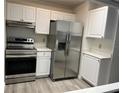 Modern kitchen featuring stainless steel appliances and white cabinets at 10842 Se 50Th Ave # 1, Belleview, FL 34420