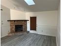 Living room with brick fireplace and wood-look flooring at 10842 Se 50Th Ave # 1, Belleview, FL 34420