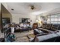 Living room with leather sofas, large TV and wood floors at 17411 Se 18Th St, Silver Springs, FL 34488