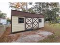 Detached storage shed with double doors in backyard at 17411 Se 18Th St, Silver Springs, FL 34488