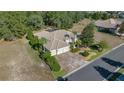 Bird's eye view of a house with a three-car garage and nicely landscaped yard at 17819 Sw 61St Lane Rd, Dunnellon, FL 34432