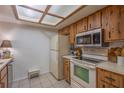Kitchen with wood cabinets, appliances, and tile floor at 3031 Se 5Th Ter # C, Ocala, FL 34471