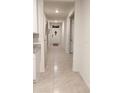 Bright hallway with tile floors, leading to rooms and entryway at 547 Tanaro Ln, Haines City, FL 33844