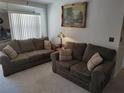 Living room with two sofas, a lamp, and framed artwork at 5500 Ne 11Th Ave, Ocala, FL 34479