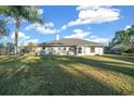 Large grassy backyard with a tree and privacy fence at 5570 Se 42Nd Ave, Ocala, FL 34480