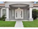 White front door with columns and covered entryway at 6298 Sw 132Nd Loop, Ocala, FL 34473