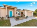 Charming one-story home with teal door and landscaped yard at 6560 Sw 129Th St, Ocala, FL 34473