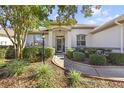 House exterior featuring a walkway and manicured landscaping at 9083 Sw 99Th Court Rd, Ocala, FL 34481