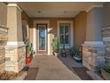 Inviting front porch with a decorative door and potted plants at 9146 Sw 65Th Loop, Ocala, FL 34481
