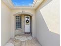 Front entry with a charming white door and stone flooring at 12157 Se 175Th Loop, Summerfield, FL 34491