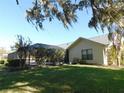 Large backyard with screened enclosure and lush landscaping at 3282 Sw 9Th Ave, Ocala, FL 34471