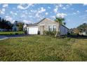 Landscaped yard with a one-story home and palm tree at 3940 Se 5Th Ave, Ocala, FL 34480