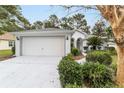 Front view of a single story home with a two-car garage at 11661 Sw 70Th Ct, Ocala, FL 34476