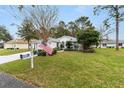 Charming one-story home with American flag and lush lawn at 11661 Sw 70Th Ct, Ocala, FL 34476