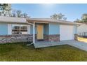 House exterior showcasing a yellow door and brick accents at 24 Banyan Dr, Ocala, FL 34472