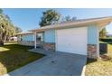 Side view of a light blue house with a white garage door at 24 Banyan Dr, Ocala, FL 34472