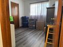 Simple bedroom with gray vinyl flooring and wooden closet at 8152 Sw 106Th St, Ocala, FL 34481