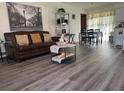 Living room with brown sofa, coffee table, and gray vinyl flooring at 8152 Sw 106Th St, Ocala, FL 34481