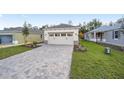 New construction home with a paved driveway and grassy lawn at 10330 Sw 99Th Ln, Ocala, FL 34481
