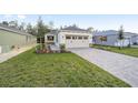 New construction home with a paved driveway and grassy lawn at 10330 Sw 99Th Ln, Ocala, FL 34481