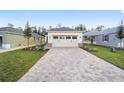 New construction home with a paved driveway and grassy lawn at 10330 Sw 99Th Ln, Ocala, FL 34481