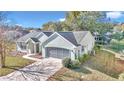 Aerial view of a single-story house with a green roof and a screened porch at 11710 Sw 77Th Cir, Ocala, FL 34476