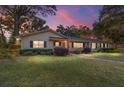 Ranch home at dusk with landscaped yard and walkway at 1416 Se 17Th Ave, Ocala, FL 34471