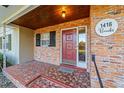 Inviting front porch with brick entryway and red door at 1416 Se 17Th Ave, Ocala, FL 34471