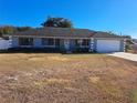 Ranch style home with a light blue exterior and a two-car garage at 17 Pecan Crse Dr, Ocala, FL 34472