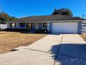 Nice curb appeal of this freshly painted light blue home with a driveway at 17 Pecan Crse Dr, Ocala, FL 34472