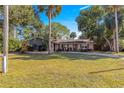 Charming ranch home with large front yard and palm trees at 21 Se Ocale Way, Summerfield, FL 34491