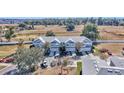 Five-unit townhome building with light blue exterior, two-car garages, and surrounding landscape at 4500 Sw 52Nd Cir # 104, Ocala, FL 34474