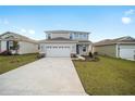 Two-story house with gray siding, stone accents, and a two-car garage at 5886 Sw 78Th Avenue Rd, Ocala, FL 34474