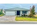 One-story home with gray siding, paver driveway, and landscaped yard at 8916 Sw 78Th Street Rd, Ocala, FL 34481