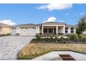 Two-car garage, landscaped yard, and a paved driveway at 9725 Sw 108Th Terrace Rd, Ocala, FL 34481