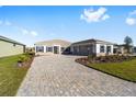 Single-story home with paver driveway and two-car garage at 9739 Sw 79Th Lane Rd, Ocala, FL 34481